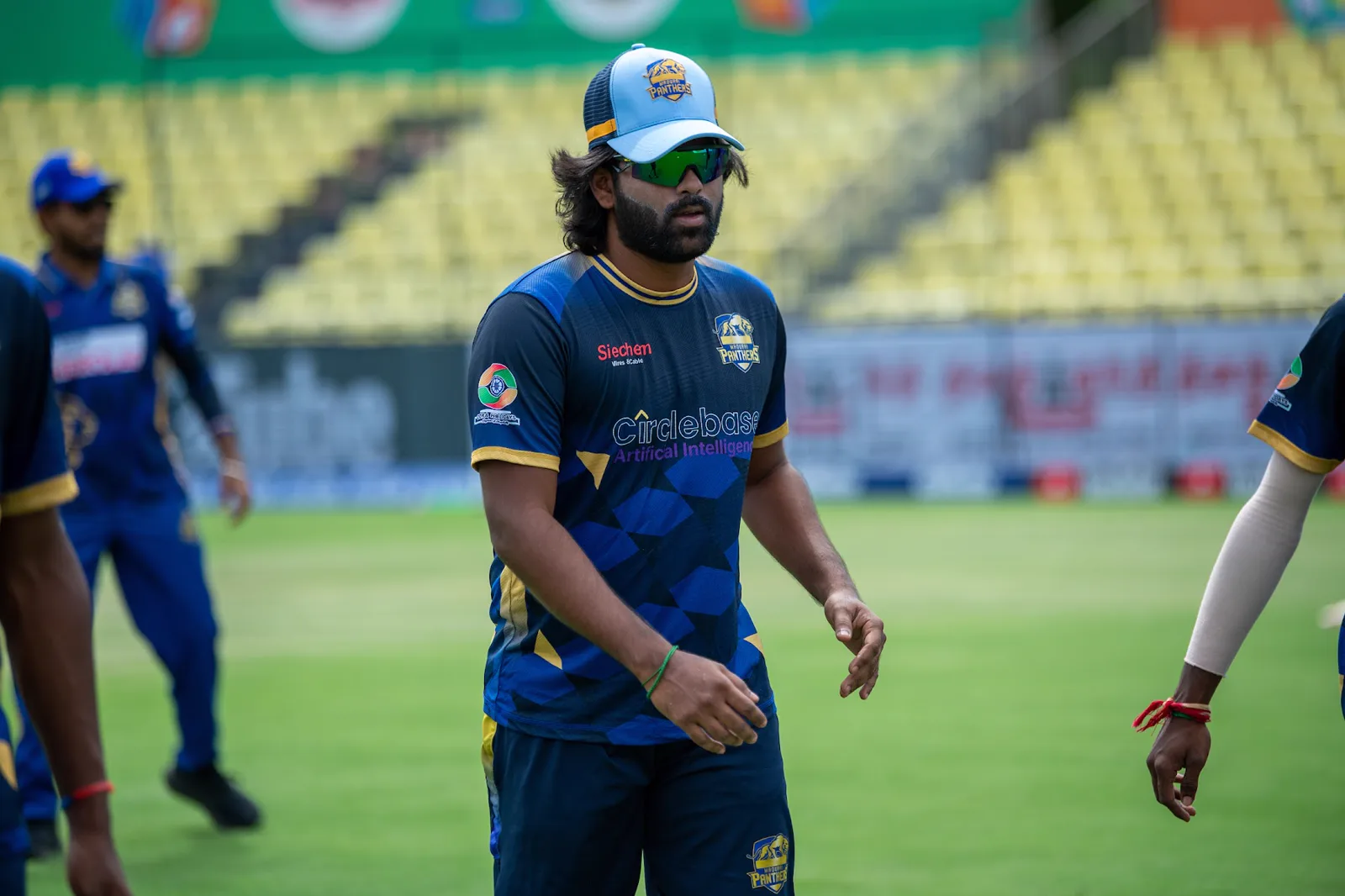 Madurai Panthers player walking onto the field against Trichy Grand Cholas